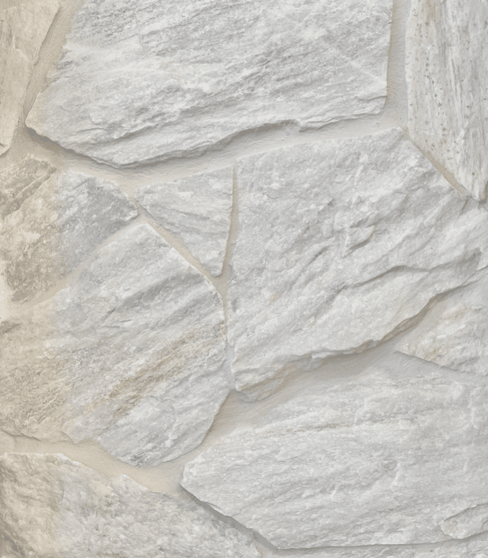 A close up shot of Tumbled Everest Quartzite installed with tonal grout on an indoor wall.