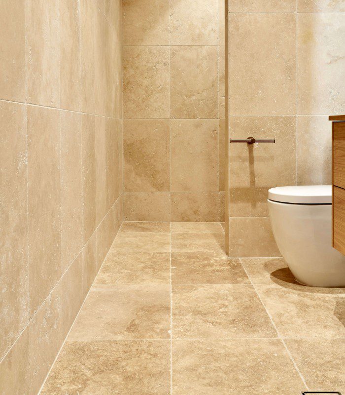 Vistala Tumbled Travertine tile used floor to ceiling in a bathroom nook.