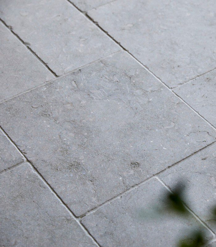 Sage Limestone French pattern is highlighted in this close-up image of flooring. Soft edges and plenty of beautiful textures are featured.