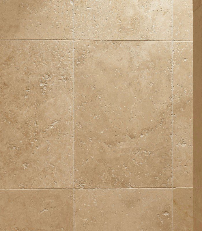 A close-up image of Vistala tumbled Travertine, highlighting the stone's cream and beige colouring and natural texture.