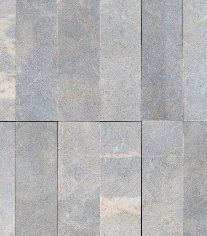 Straight stacked tiles. Tumbled Ironside marble is a bespoke tile selection highlighting natural greys and burnt orange.