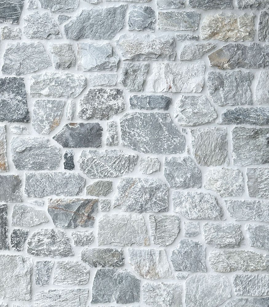 Stacked limestone with white grout. The stone work pattern showcases an array of greys and features light brown tones.