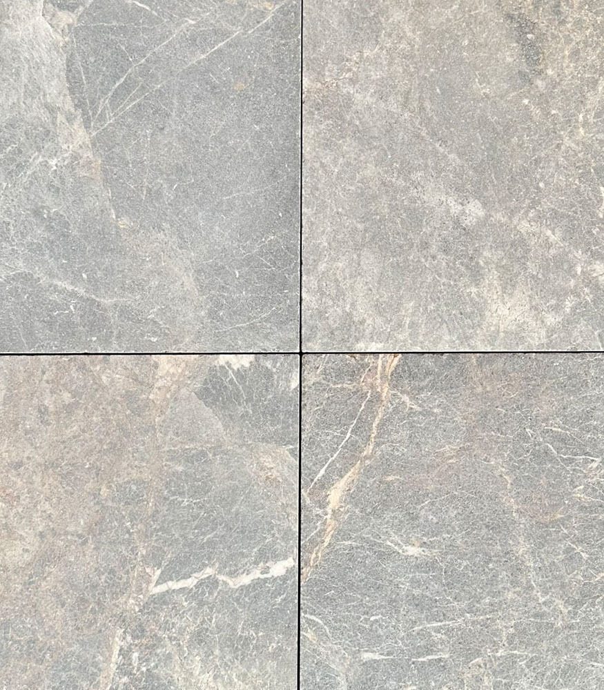 Tommy marble flooring square tiles without grouting. The close up image showcases the fine white lines and natural golden veins in the stone.