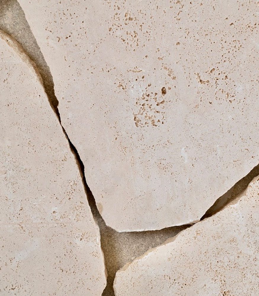 Vistala Travertine natural stones with tumbled edges. The stone showcases the porous texture and cream colouring.