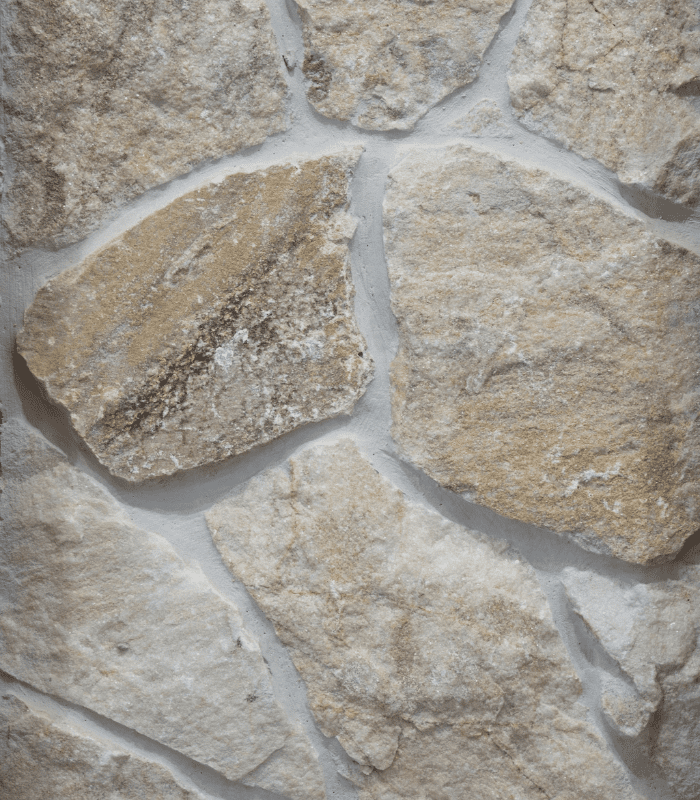 This close-up image showcases Somerton Irregular Quartz Limestone as grouted wall cladding. The natural stone’s rich colouring stands out from the white grouting.